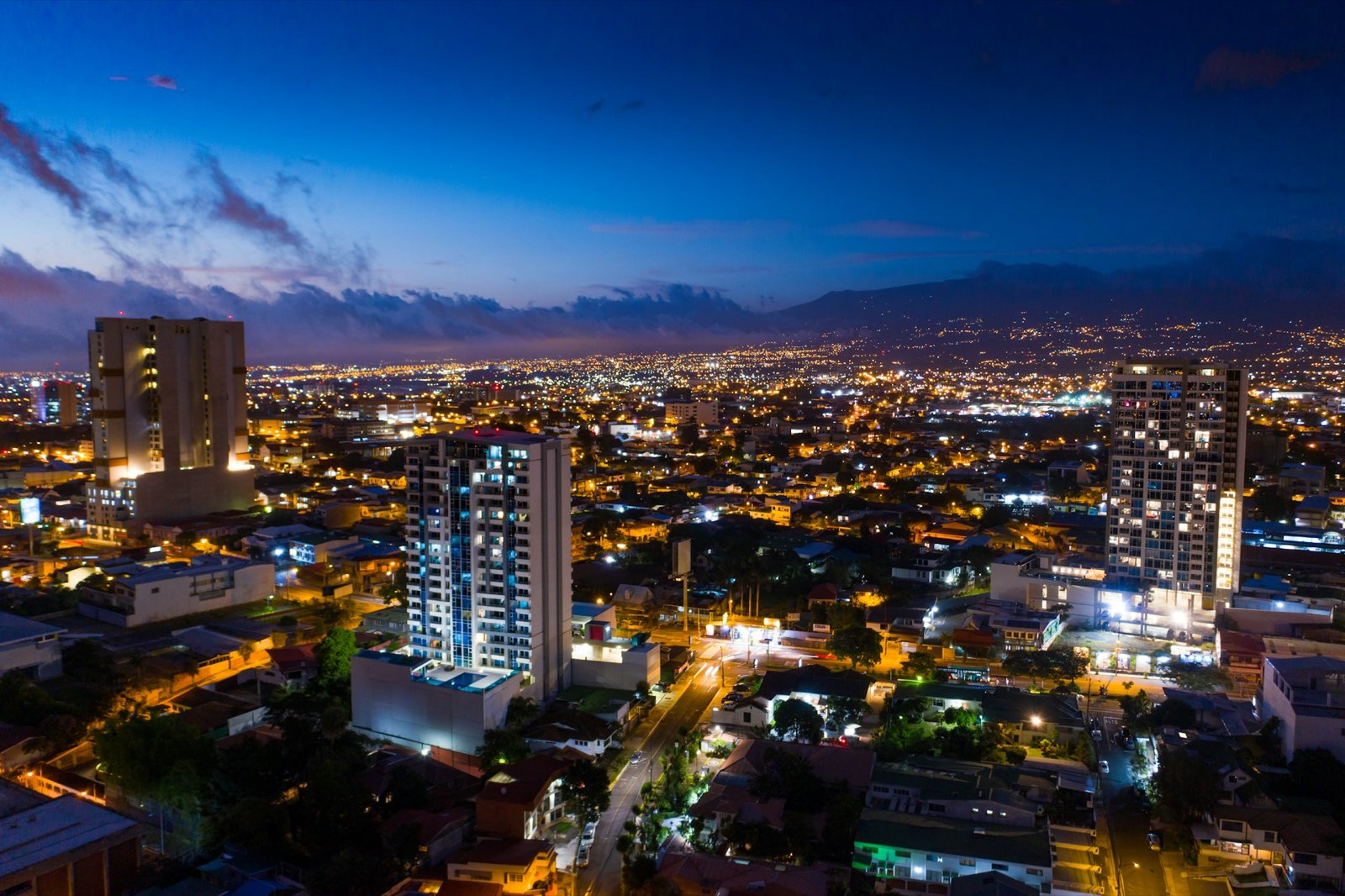 San Jose, Costa Rica city lights at night with mountains in the background